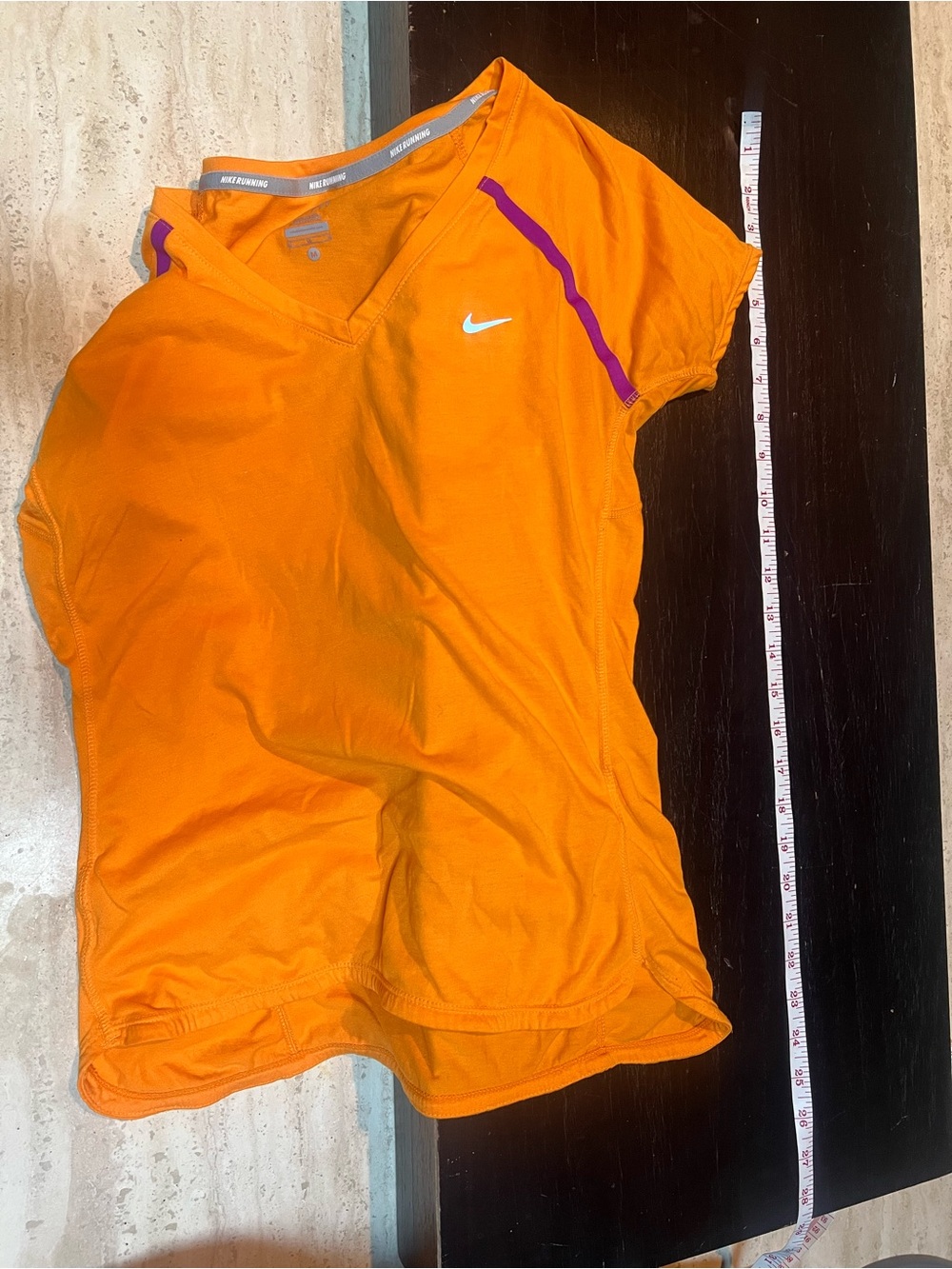 Nike Dri-FIT short-sleeve V-neck athletic running shirt.